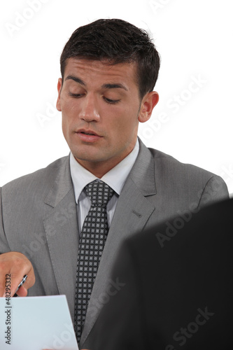 Photo: Businessman talking about a document in a meeting Businessman talking about a document in a meeting