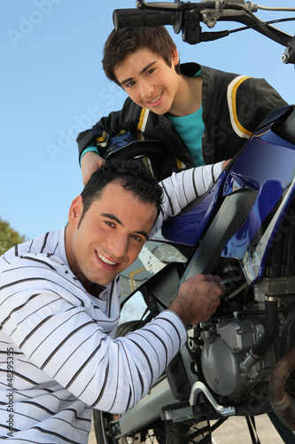 Photo: Father and son with a motorbike Father and son with a motorbike