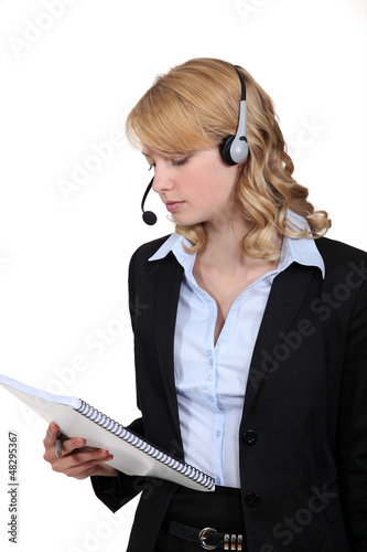 Photo: Call-center worker with note pad Call-center worker with note pad