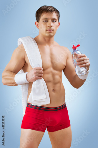 Photo: a handsome young sportsman with water a handsome young sportsman with water