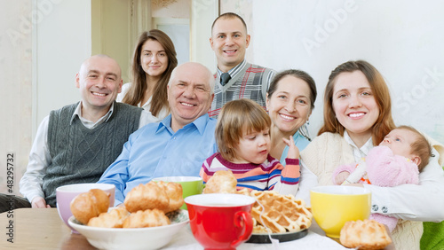Photo: happy family or group of friends over tea happy family or group of friends over tea