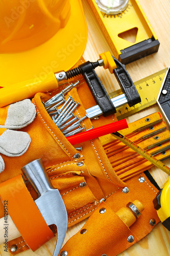 Photo: tools in belt and hardhat tools in belt and hardhat