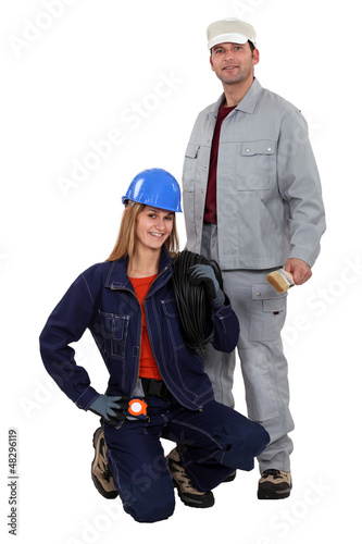 Photo: Electrician kneeling by painter Electrician kneeling by painter