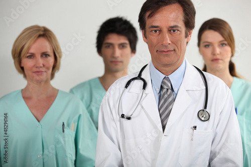 Photo: A doctor and three nurses behind him, all looking at us. A doctor and three nurses behind him, all looking at us.