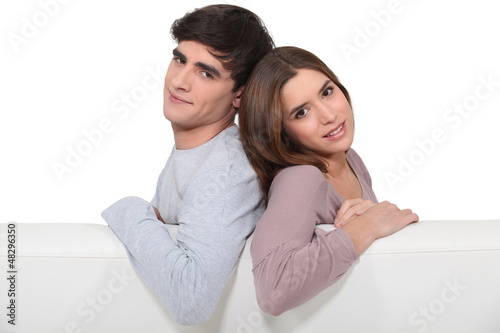 Photo: Couple stood behind blank poster Couple stood behind blank poster
