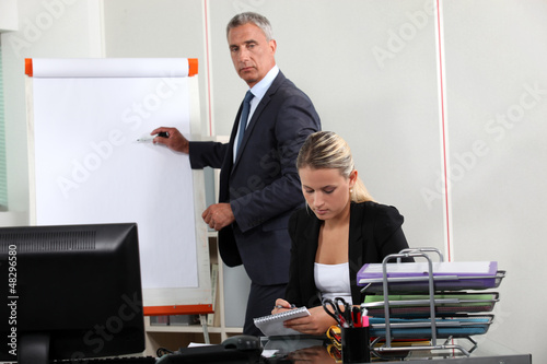 Photo: Businessman stood by flip-chart Businessman stood by flip-chart