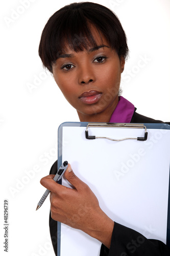 Photo: Black woman holding a clipboard. Black woman holding a clipboard.