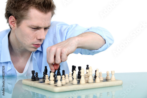 Photo: Man playing chess alone Man playing chess alone
