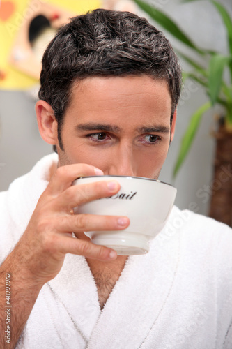 Photo: Man in bathrobe having breakfast Man in bathrobe having breakfast