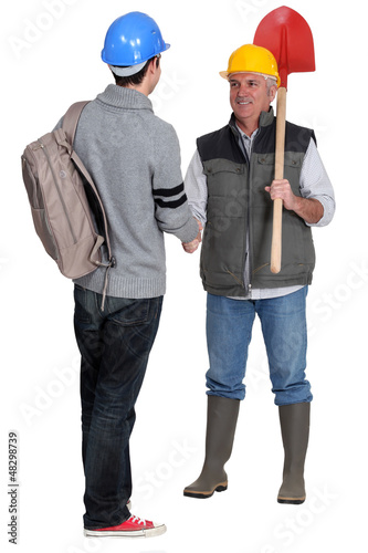 Photo: A construction worker and his apprentice. A construction worker and his apprentice.