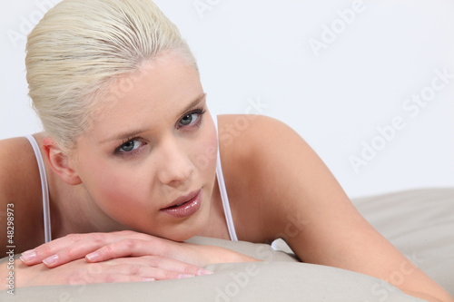 Photo: Blonde woman lying in bed Blonde woman lying in bed