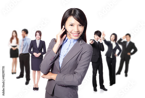 Photo: Smiling call center executive with colleagues Smiling call center executive with colleagues