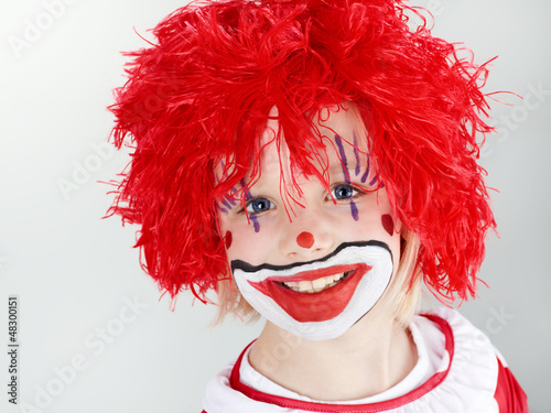 Photo: Beautiful child as a funny clown with red hair Beautiful child as a funny clown with red hair