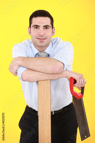 Photo: Businessman with hand-saw Businessman with hand-saw