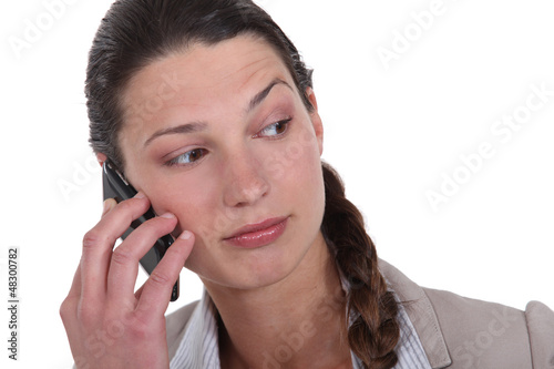 Photo: woman with cell phone looking puzzled woman with cell phone looking puzzled