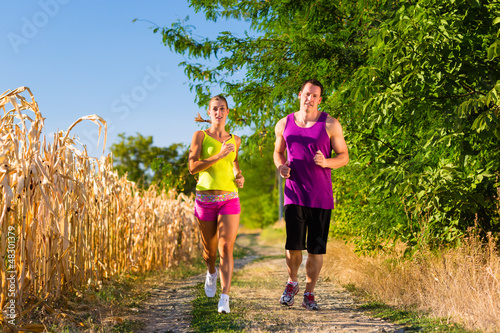 Photo: Man and woman running for sport Man and woman running for sport