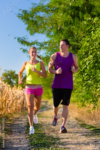Photo: Man and woman running for sport Man and woman running for sport