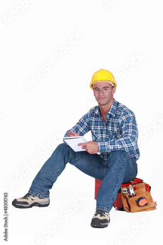 Photo: Craftsman with notebook sitting on toolbox Craftsman with notebook sitting on toolbox