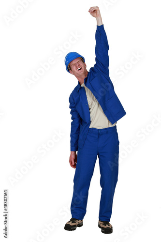 Photo: Manual worker raised clenched fist in the air Manual worker raised clenched fist in the air