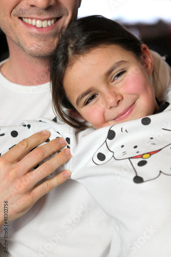 Photo: Father and daughter sat on sofa Father and daughter sat on sofa