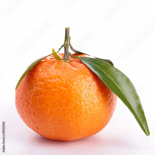 Photo: Ripe sweet tangerine isolated on white Ripe sweet tangerine isolated on white