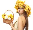 beautiful young woman with yellow autumn wreath and basket with