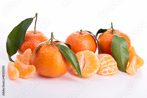 Photo: Ripe sweet tangerine isolated on white Ripe sweet tangerine isolated on white