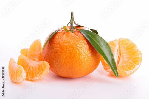 Photo: Ripe sweet tangerine isolated on white Ripe sweet tangerine isolated on white