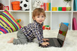 cute little boy and notebook in room