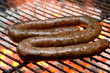 Photo: Tradtional South African braai barbecue borewors sausage on fire Tradtional South African braai barbecue borewors sausage on fire