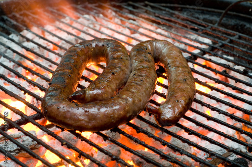 Photo: Tradtional South African braai barbecue borewors sausage on fire Tradtional South African braai barbecue borewors sausage on fire