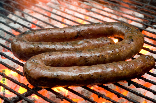 Photo: Tradtional South African braai barbecue borewors sausage on fire Tradtional South African braai barbecue borewors sausage on fire