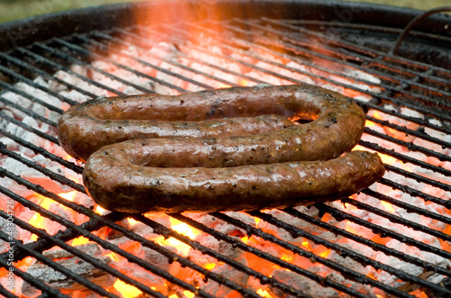Photo: Tradtional South African braai barbecue borewors sausage on fire Tradtional South African braai barbecue borewors sausage on fire