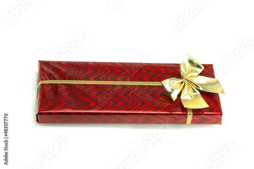 Photo: Red gift with a bow tied up by a ribbon Red gift with a bow tied up by a ribbon