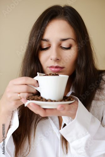 Photo: brunette enjoying smell of coffee brunette enjoying smell of coffee