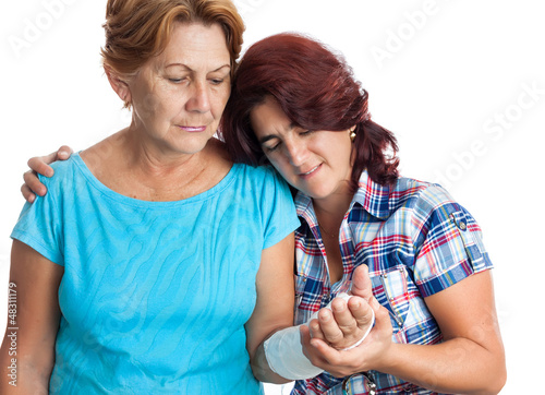 Photo: Elderly woman with a broken arm and her caregiver Elderly woman with a broken arm and her caregiver