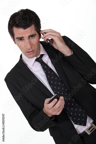 Photo: Businessman with two phones. Businessman with two phones.