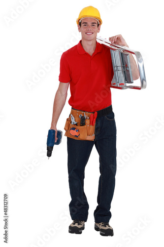 Photo: happy young carpenter carrying ladder isolated on white happy young carpenter carrying ladder isolated on white