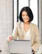 happy woman with laptop computer and credit card