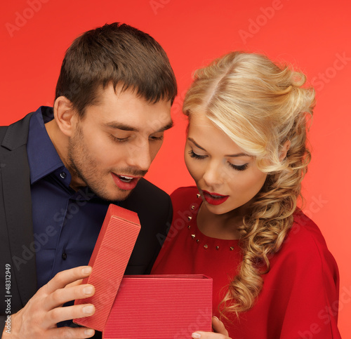 Photo: man and woman looking inside the gift box man and woman looking inside the gift box