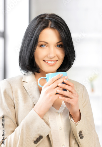 Photo: lovely businesswoman with mug lovely businesswoman with mug