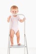 Photo: Impish little girl standing on top of ladder Impish little girl standing on top of ladder