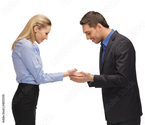 Photo: man and woman showing something on the palms man and woman showing something on the palms