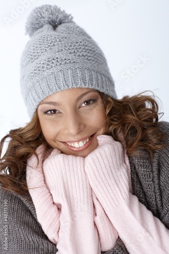 Photo: Beautiful ethnic girl smiling in winter outfit Beautiful ethnic girl smiling in winter outfit