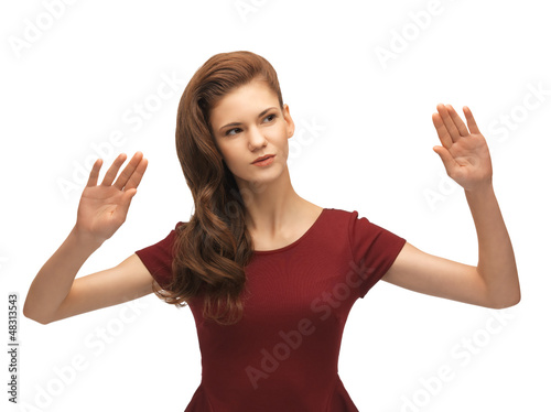 Photo: girl in red dress working with something imaginary girl in red dress working with something imaginary