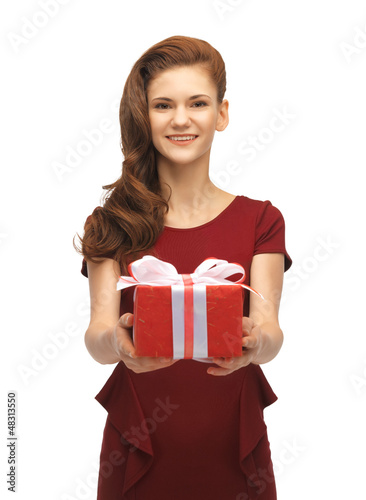 Photo: teenage girl in red dress with gift box teenage girl in red dress with gift box