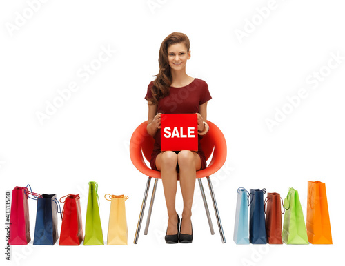 Photo: girl in red dress with shoes, bag and sale sign girl in red dress with shoes, bag and sale sign