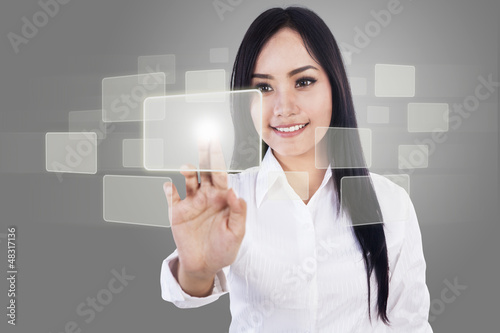 Photo: Beautiful businesswoman and touch screen Beautiful businesswoman and touch screen