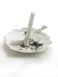 Photo: broken cigarette on white ash-tray broken cigarette on white ash-tray