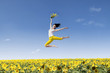 Girl dance over yellow sunflowers